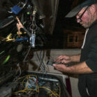 Nelson rearranges the back of his car and recharges his phone. He sleeps on four stacked blankets in the back seat. Sometimes he folds down the seat to stretch his legs into the trunk. He has attached a solar panel to the roof to power essential electronics. “The key to the solar deal is storage,” Nelson said. “I have two batteries separate from the car, so I can run a television, a DVD player and charge up my phone. Now the next question is: How long can I run it for? I would be good for an hour or two. Anything crazy and heavy like a microwave or refrigerator is going to eat you up really quick.” But bad wiring inside his trunk has proven hazardous. One afternoon while Nelson was charging his devices, an electrical short melted the plastic of the cigarette lighter plug and filled his car with smoke. “I’m lucky I didn’t kill myself,” he said.