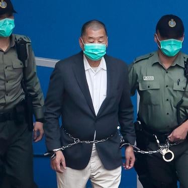 In this December. 12, 2020, file photo, Jimmy Lai,  center, who founded the pro-democracy newspaper Apple Daily, is escorted by Correctional Services officers to get on a prison van before appearing in a court.