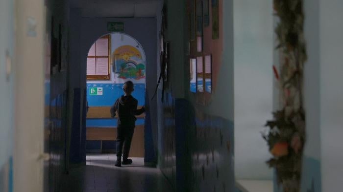 A child walks down a hallway