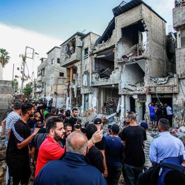 Palestinians inspect a damaged building