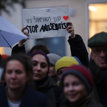 A demonstrator holds a sign during a vigil outside a community center and synagogue in Berlin, Germany, on October 20, 2023. 
