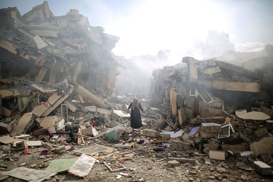 A resident walks amid the rubble of residential buildings after Israeli airstrikes in al-Zahra neighborhood in the Gaza Strip, October 19, 2023. 