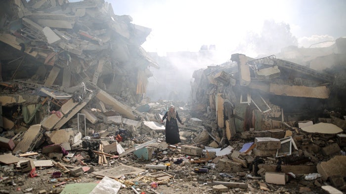 A resident walks amid the rubble of residential buildings after Israeli airstrikes in al-Zahra neighborhood in the Gaza Strip, October 19, 2023. 