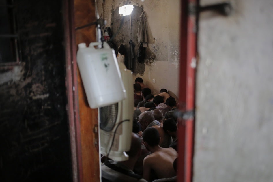 Suspected Islamic State members sit inside a small room in a prison south of Mosul, Iraq, July 18, 2017.