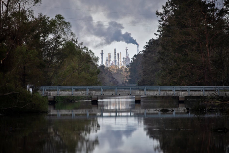 Smoke and flares from an industrial plant seen over a body of water