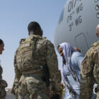 Evacuees from Afghanistan arrive at Ali Al Salem Air Base, Kuwait, on an aircraft crewed by Air National Guard members on Aug. 23, 2021.