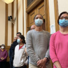 People standing in line at a public meeting at San Francisco City Hall.