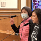 At a City Hall meeting in San Francisco, an interpreter helps a resident make a public comment.