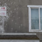 A sign covered in bird droppings that sits above a doorway at San Francisco's Plaza East public housing development reads "No Trespassing. SFHA Property." Tenants at Plaza East describe units that are as damaged and neglected on the inside as they appear externally.