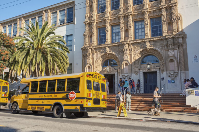 A school bus parked in front of Mission High School in San Francisco.