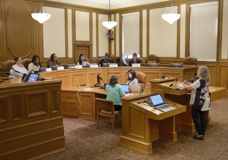 A member of the public comments during a session of the Our City, Our Home Oversight Committee.