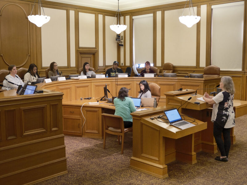 A member of the public comments during a session of the Our City, Our Home Oversight Committee.