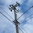 A utility pole and power lines are seen from below. For years, residents of San Francisco’s Treasure Island have faced frequent power outages that complicated daily life.