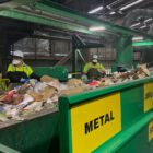 Workers at the initial sort deck inside Recology’s sorting facility at Pier 96 in San Francisco pluck items that cannot be recycled or pose a threat to equipment from a conveyor belt.