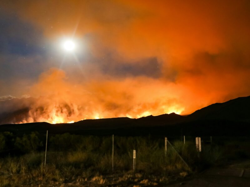 A wildfire rages in the distance, in California's Sierra Nevada mountains.