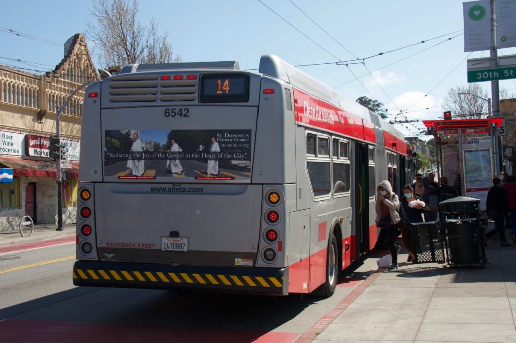 People boarding a 14 Mission bus at Mission and 30th streets are wearing masks, but don’t seem to be following distance protocol on April 10.