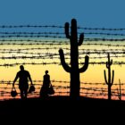 Silhouettes of two people crossing the desert.